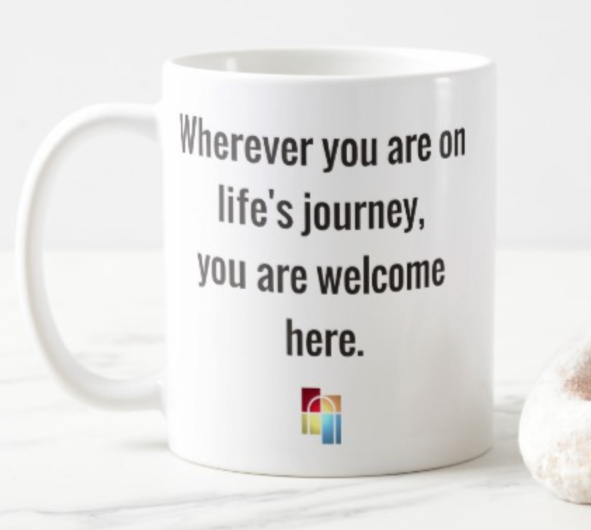 white coffee mug that says "where you are on life's journey, you are welcome here"